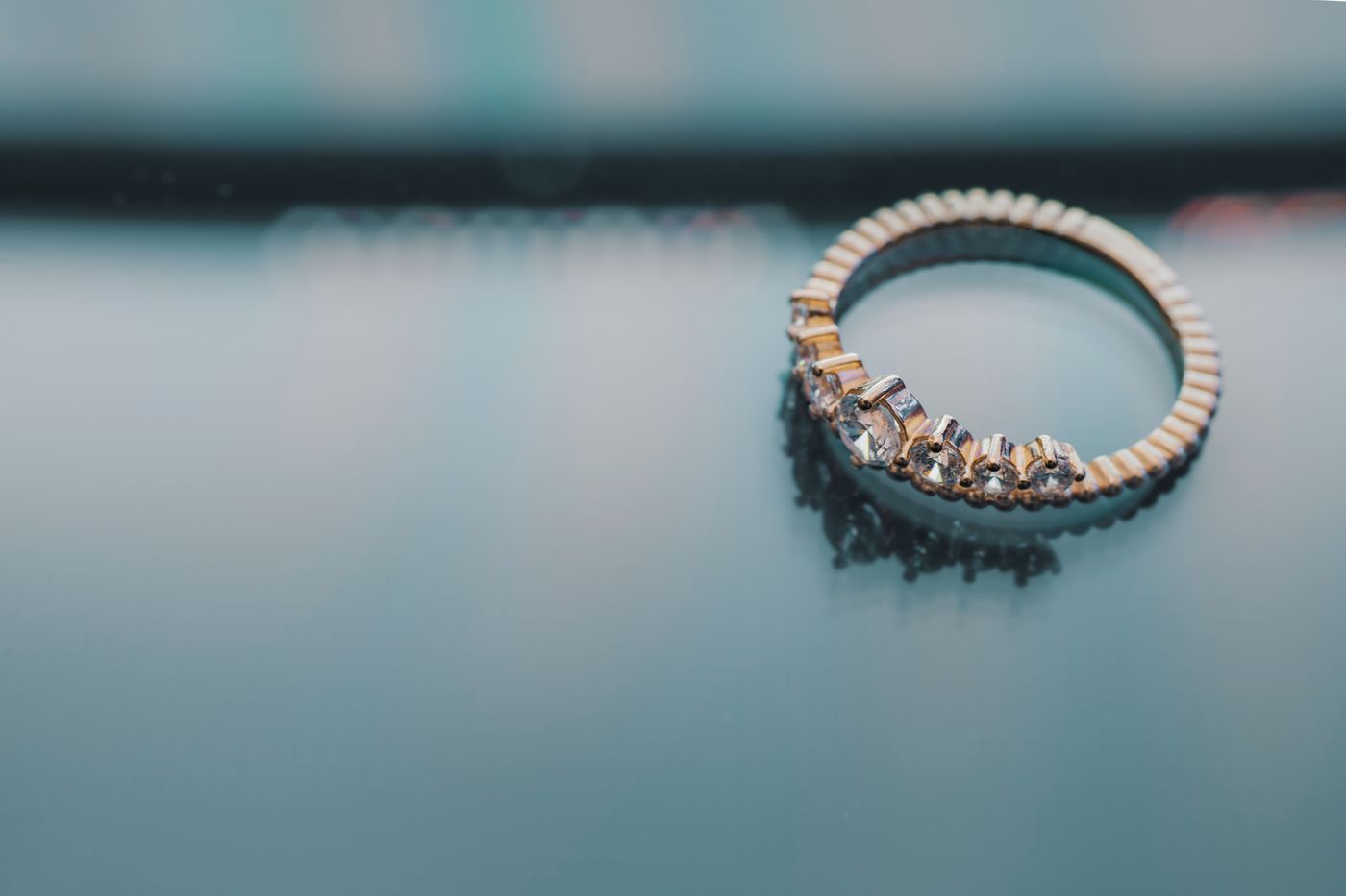 A handmade gemstone ring resting on a polished surface