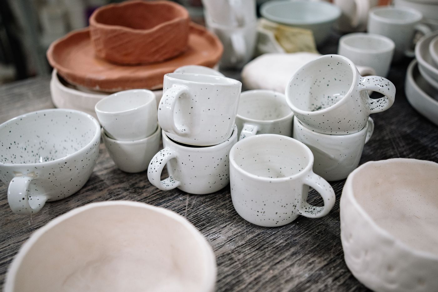 Speckled handmade ceramic mugs and bowls