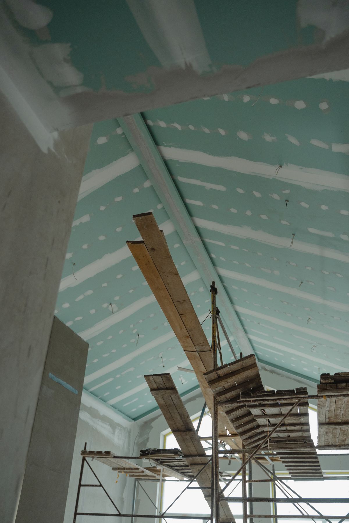 A drywall ceiling boarded out to the framing with taped seams
