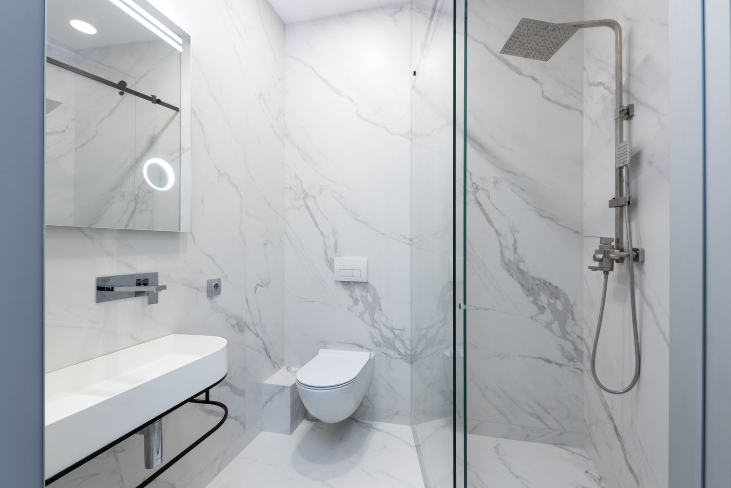Renovated bathroom with tiled walk-in shower and glass