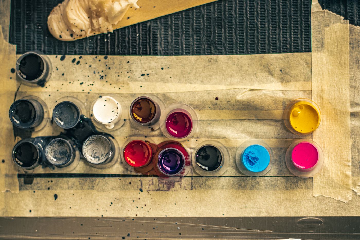 Caps of coloured tattoo ink seen from above