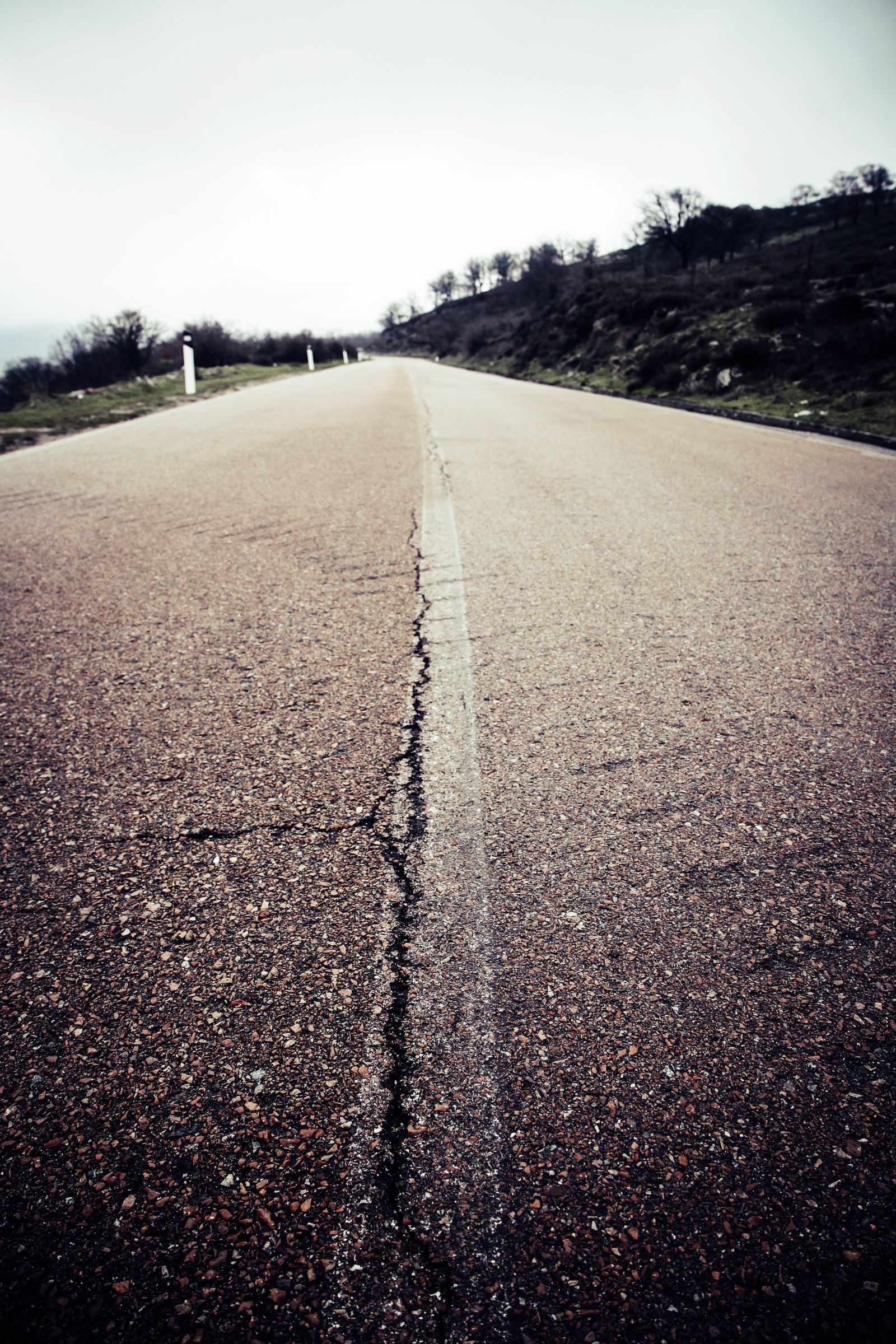 Cracked asphalt surface before repair