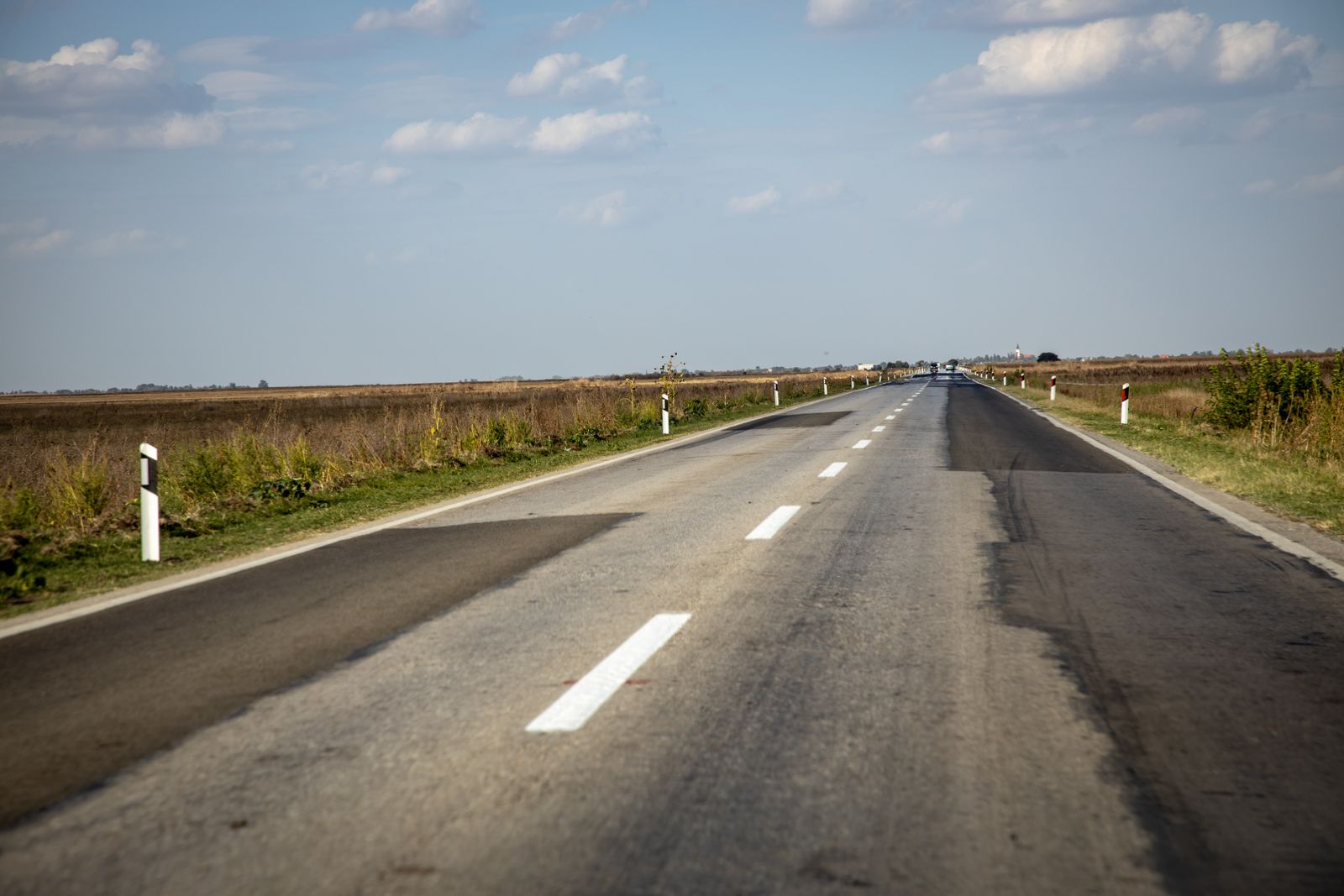 Smooth straight asphalt surface with painted lane line