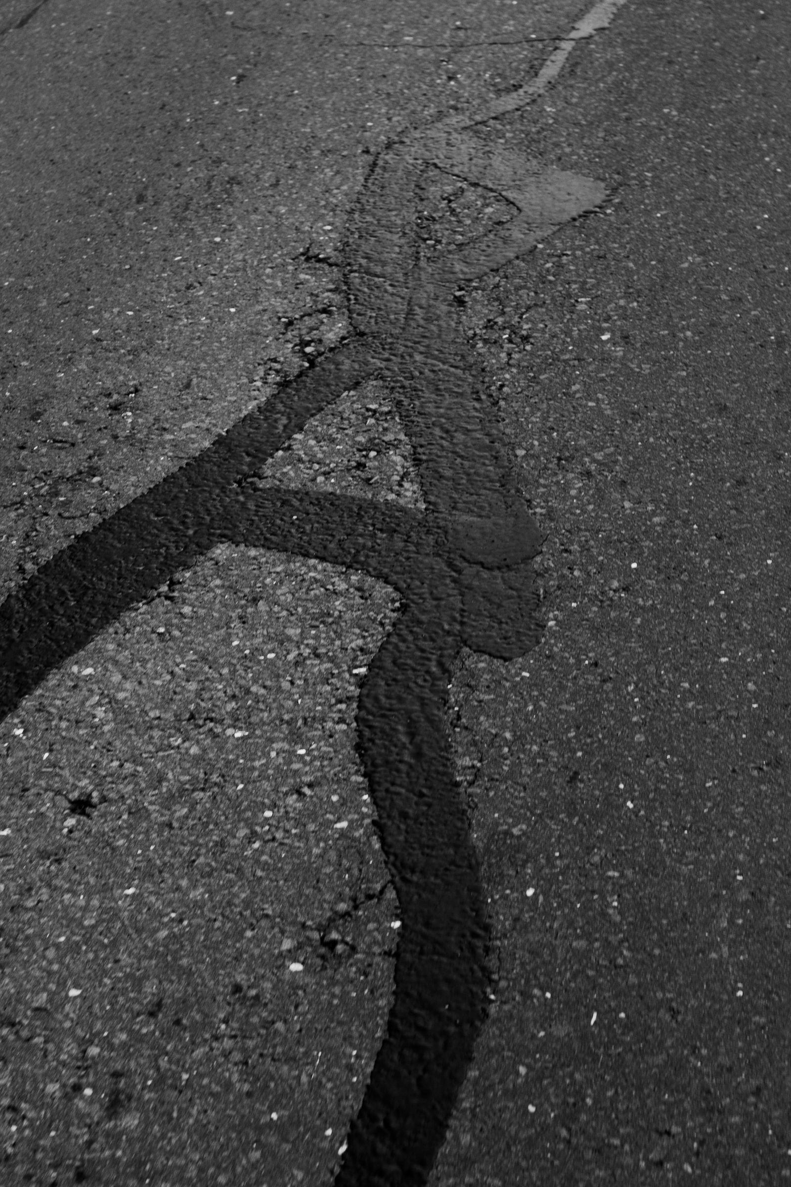 Cracked asphalt surface before repair