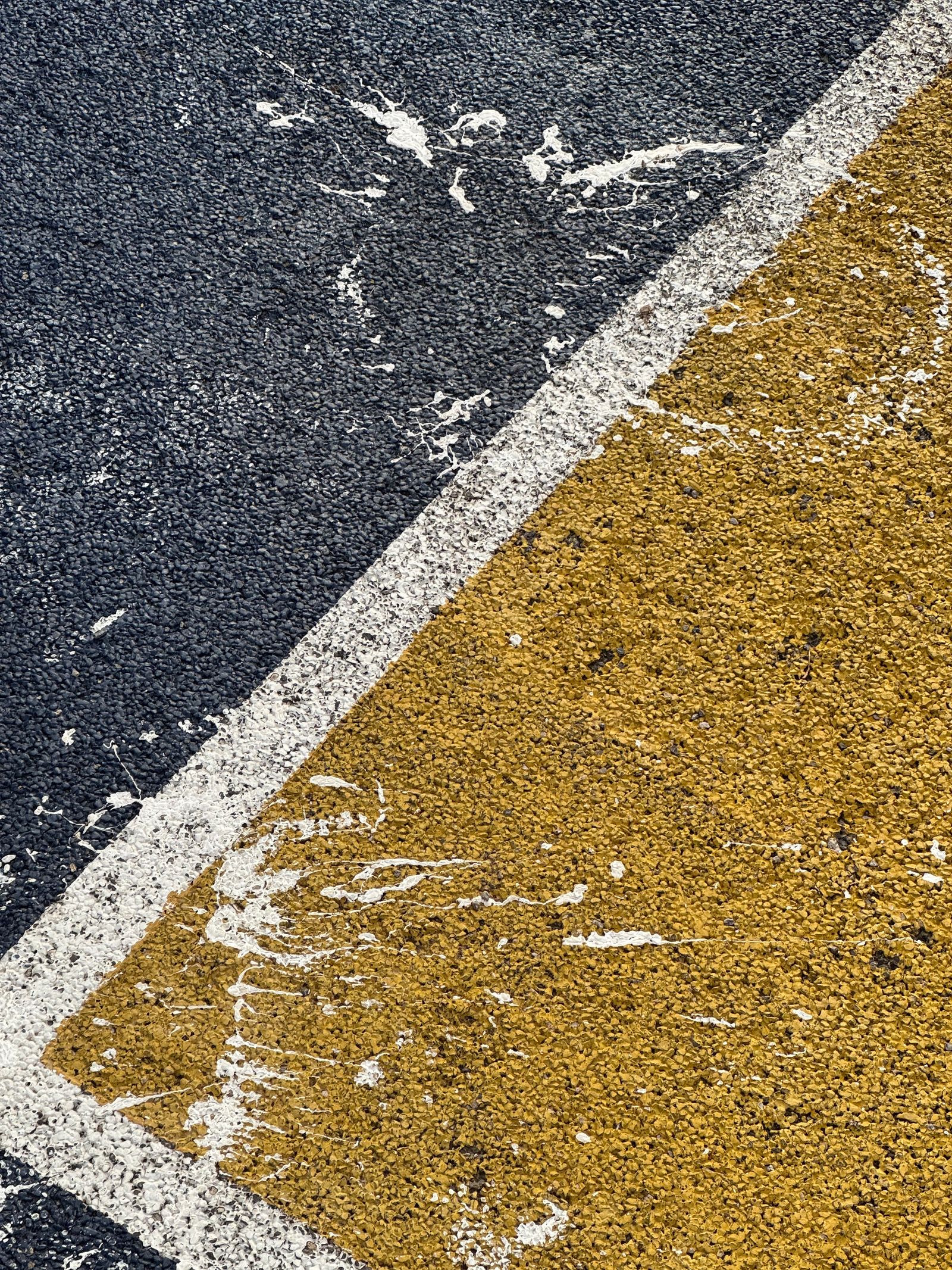 Fresh yellow and white line paint on asphalt