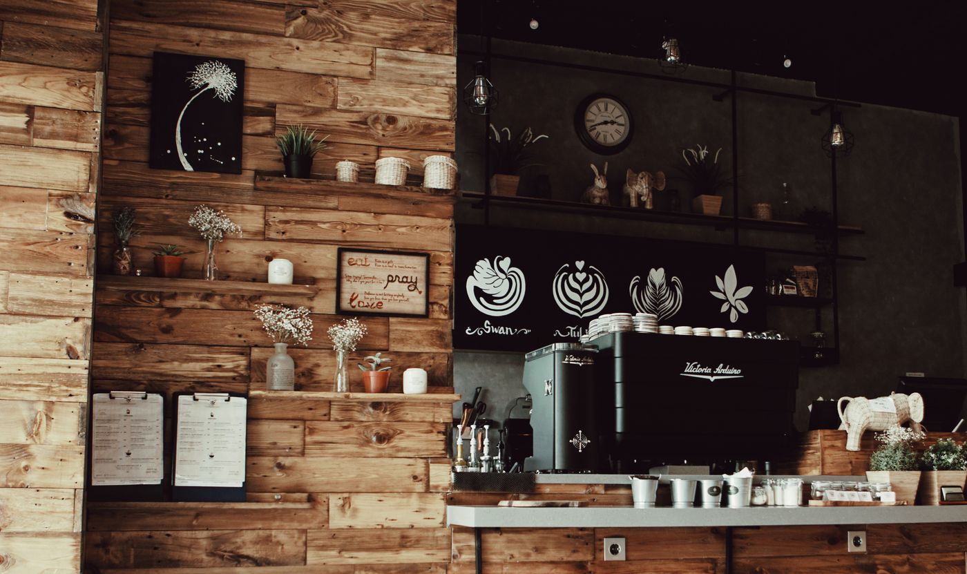 Cozy European cafe interior with wood walls and an espresso machine