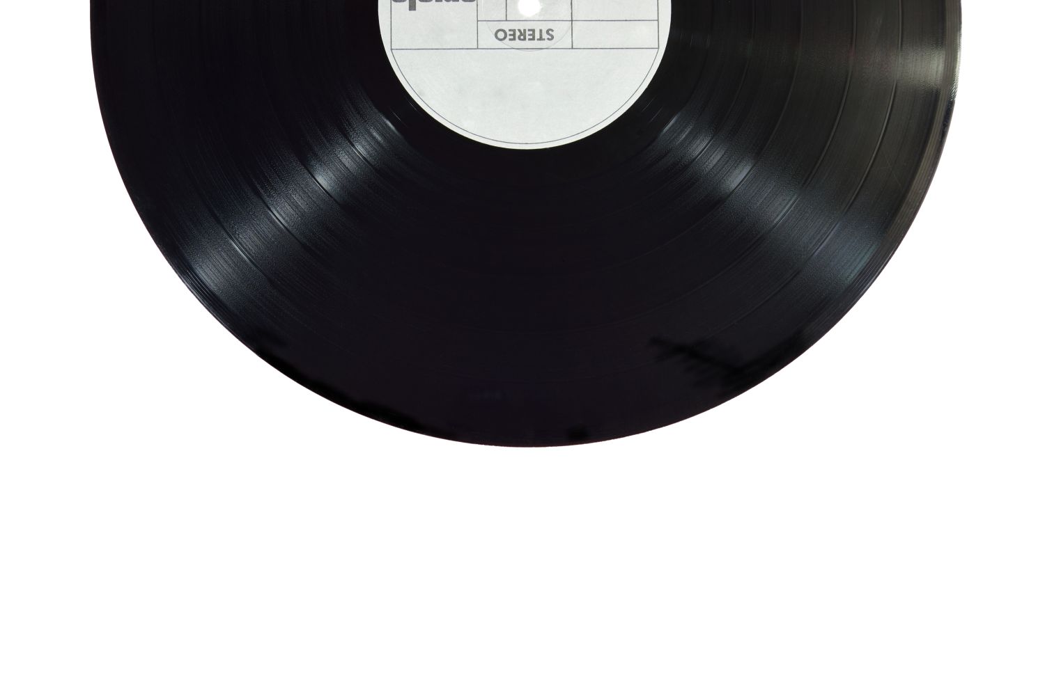 A vinyl record being lifted from its sleeve