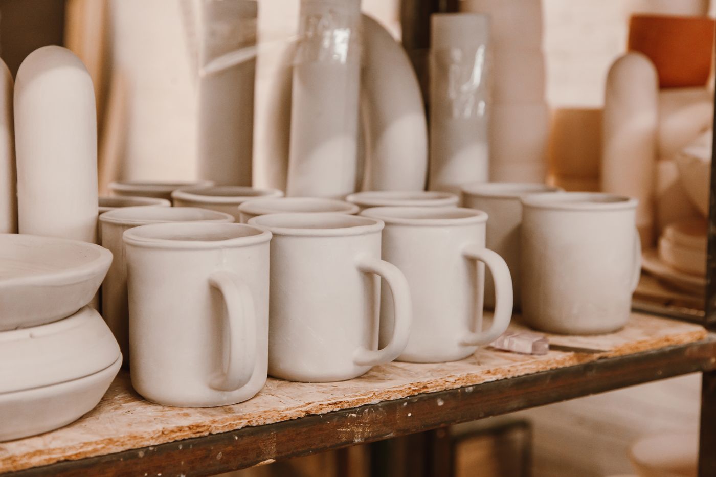 Unglazed greenware mugs awaiting the kiln