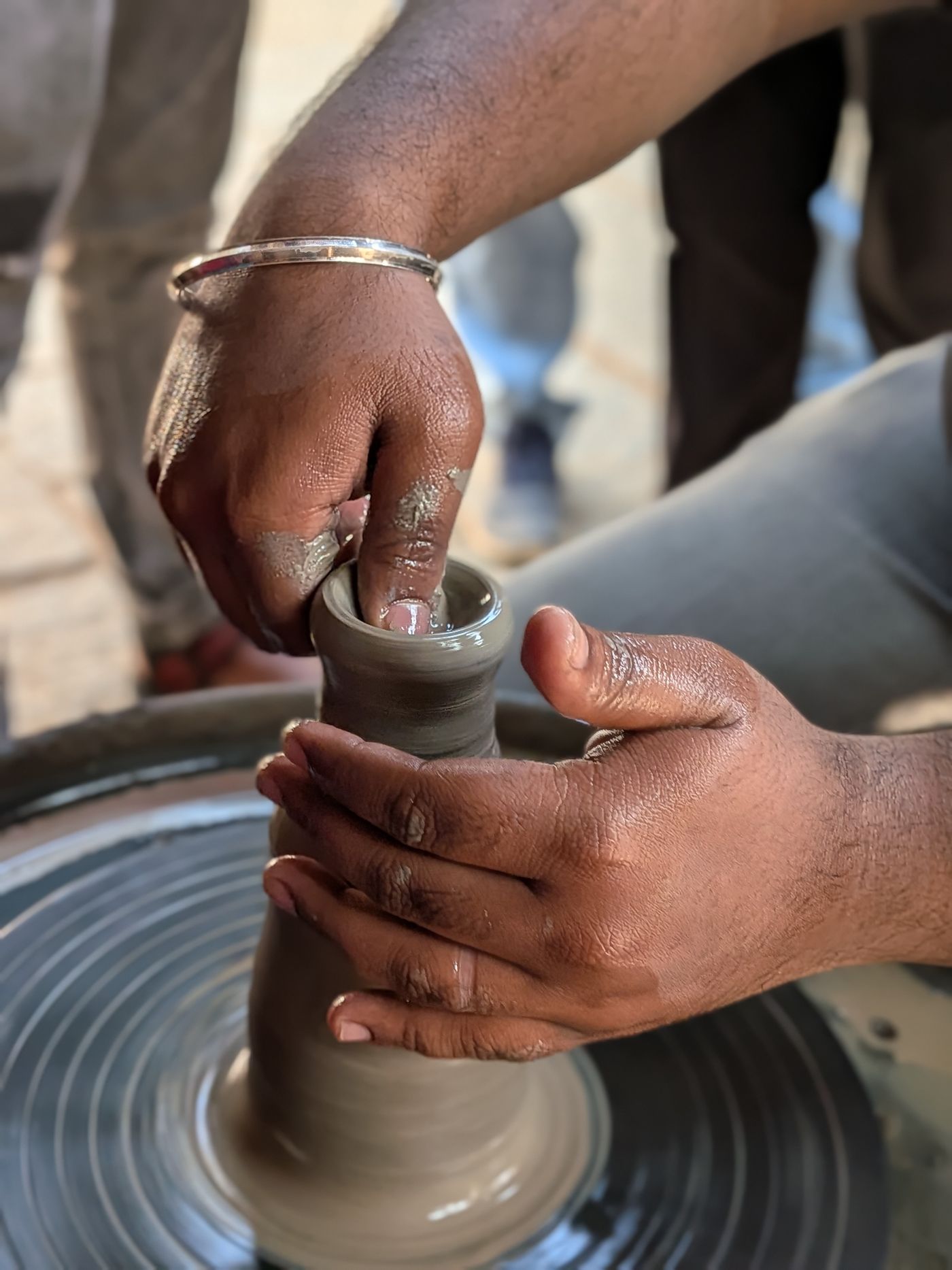 Hands on a pottery wheel