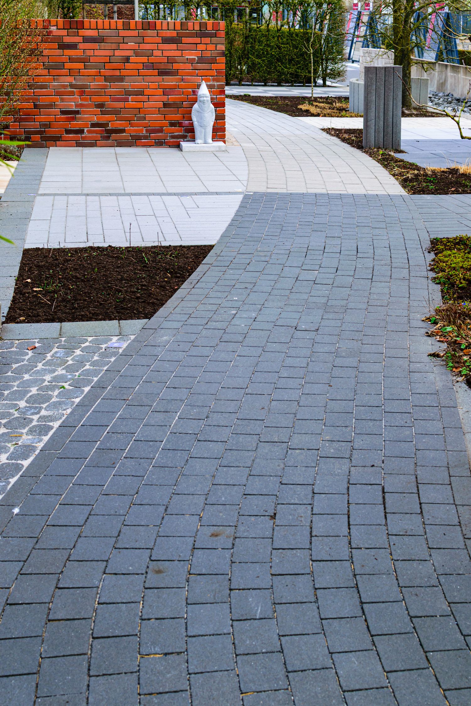 A curved brick walkway in a garden