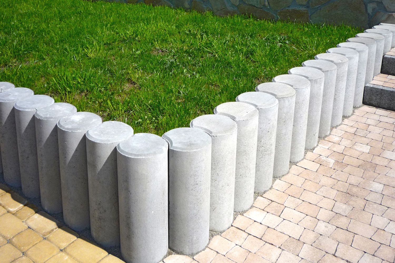 Edge restraint blocks set along a lawn