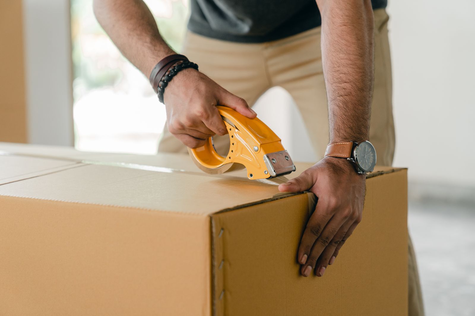 Sealing a moving box with packing tape