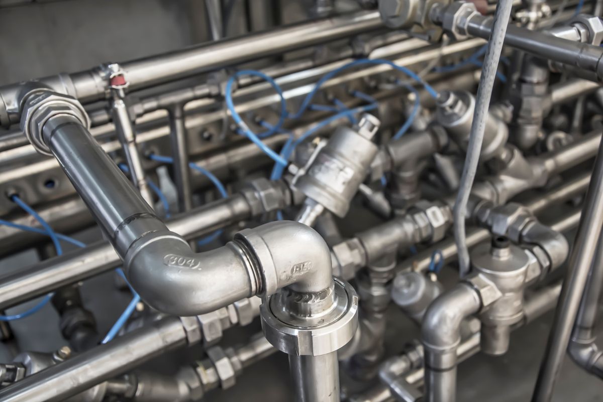 Close-up of stainless steel pipe fittings and valves