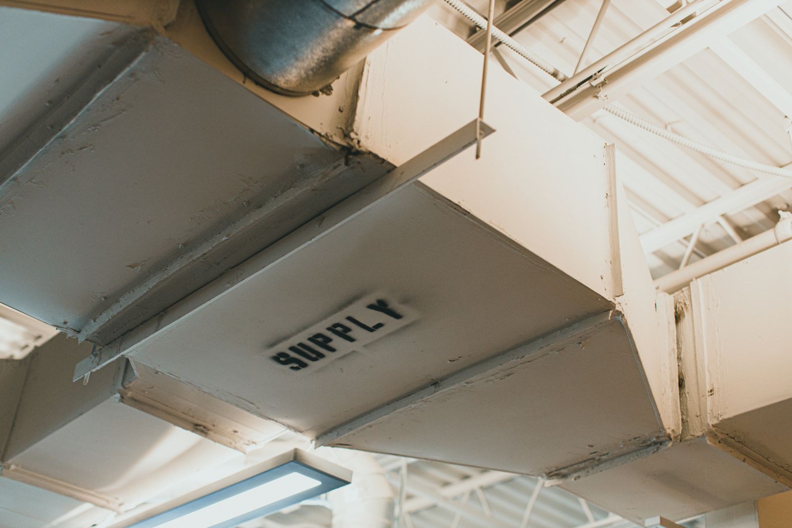 White metal supply air duct in a mechanical space