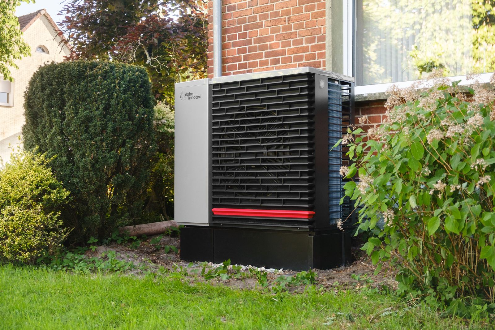 Energy-efficient heat-pump unit installed in a green residential garden