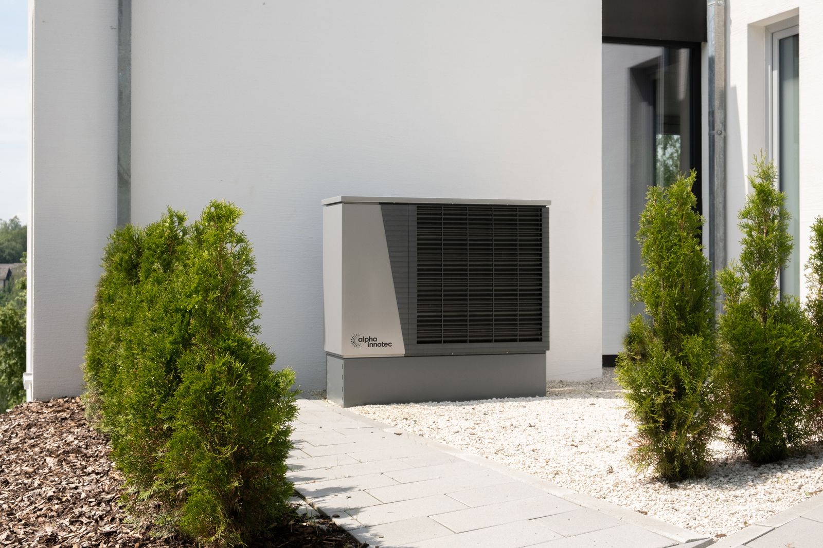 Modern outdoor heat-pump units beside a contemporary home