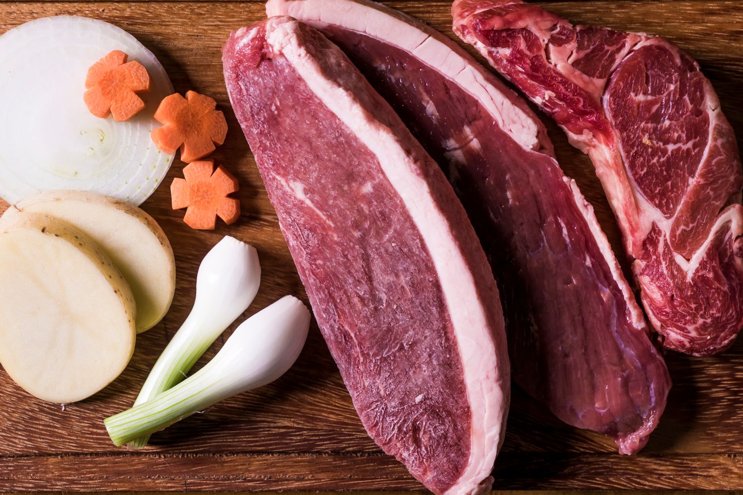 Raw lamb chops arranged with onion