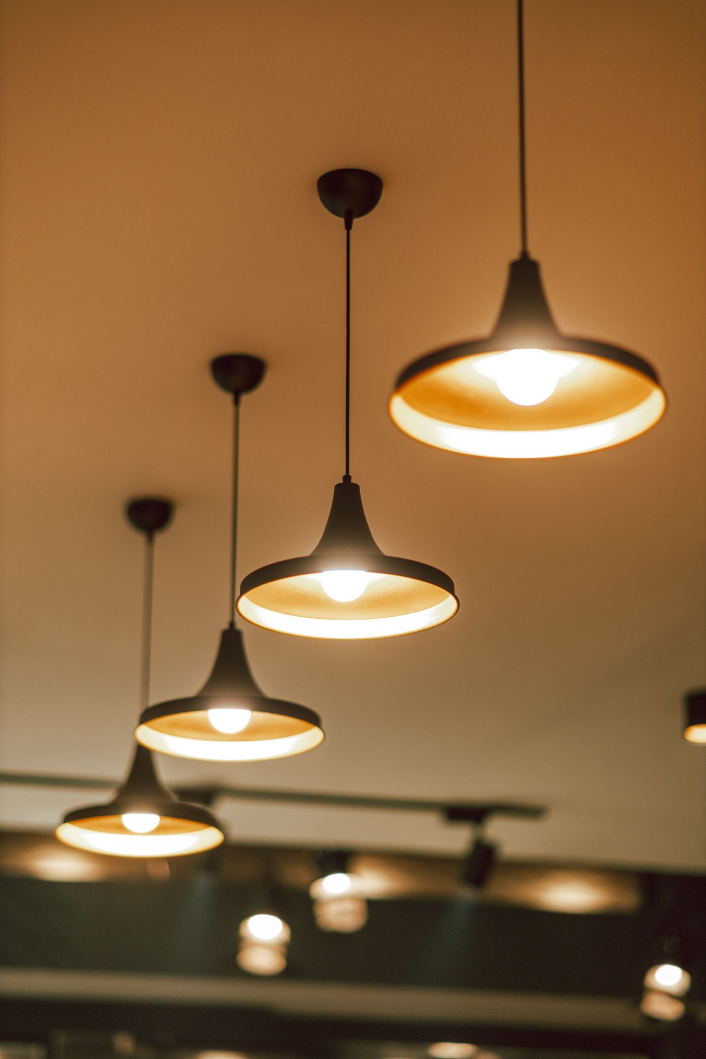 Warm pendant light fixtures installed over a counter