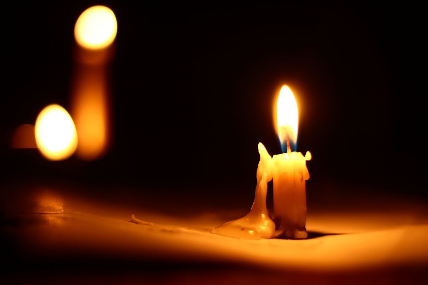 A lit candle in warm light