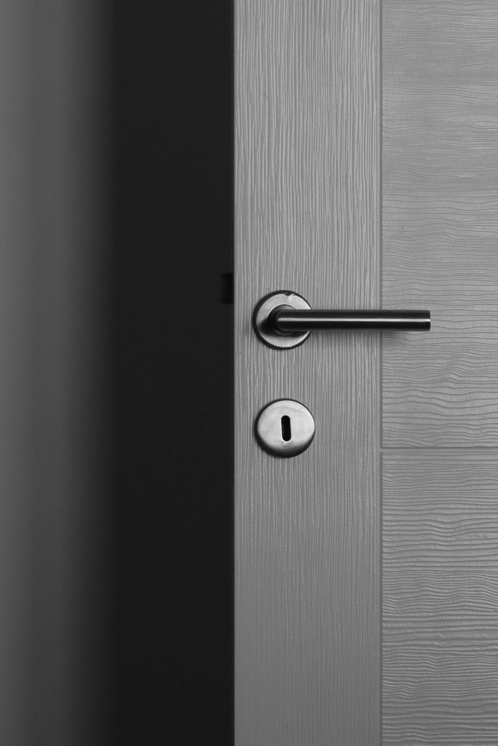 A modern grey door with lever handle