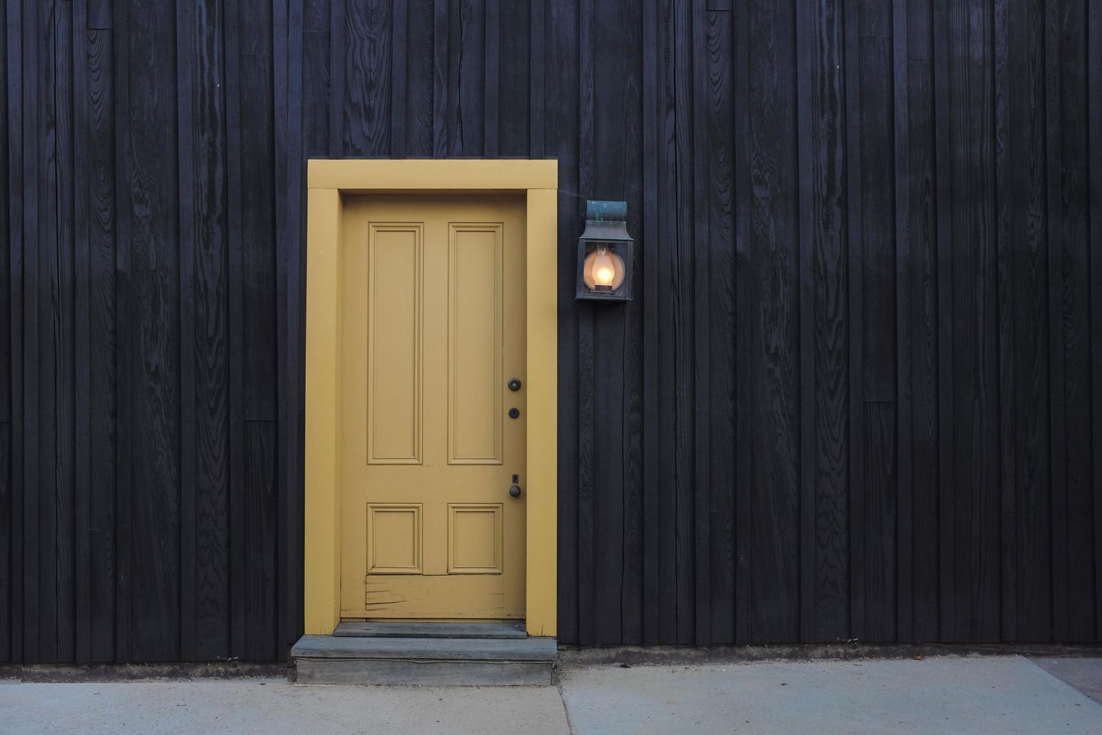 A solid wood exterior door, freshly hung and finished
