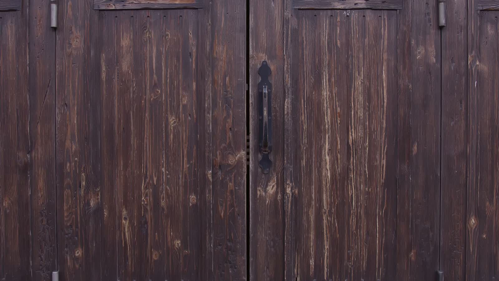 Dark wooden doors with hand-set hardware