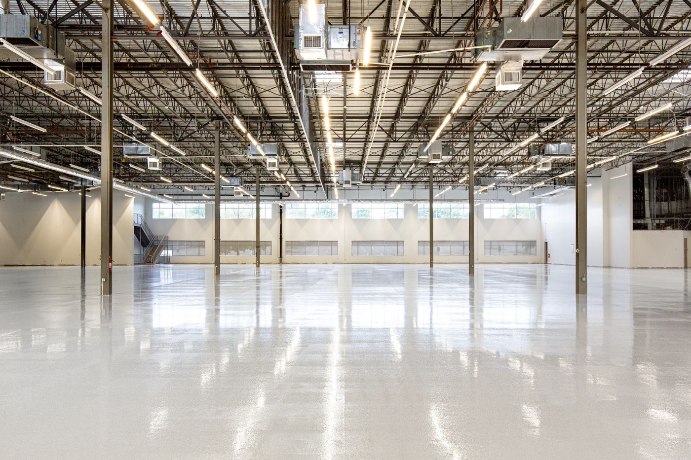 A large prepped warehouse floor coated in even epoxy