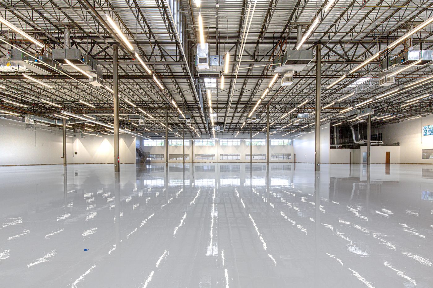 A large open space with a glossy seamless epoxy-coated floor