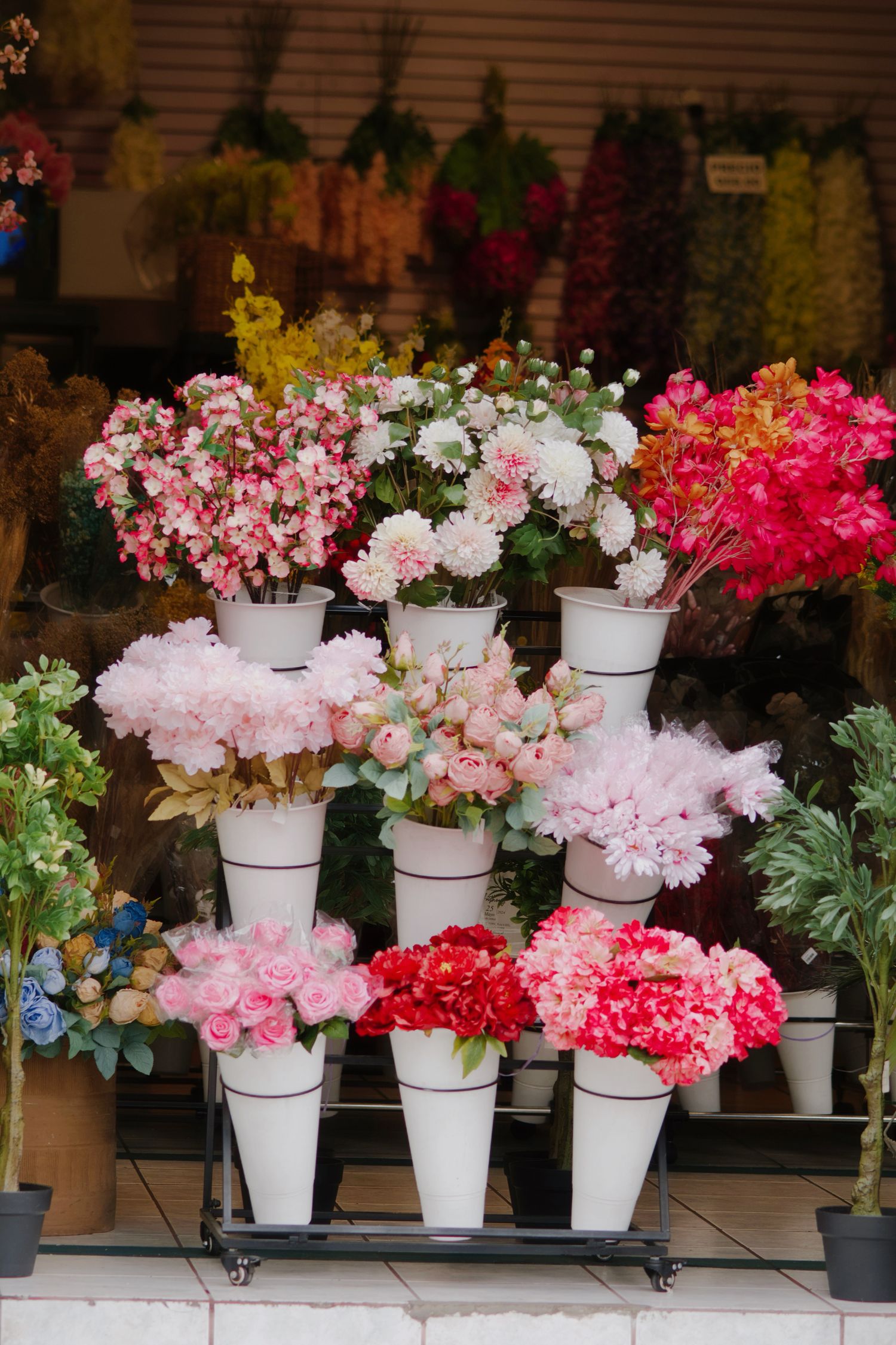 Buckets of fresh blooms at the entrance