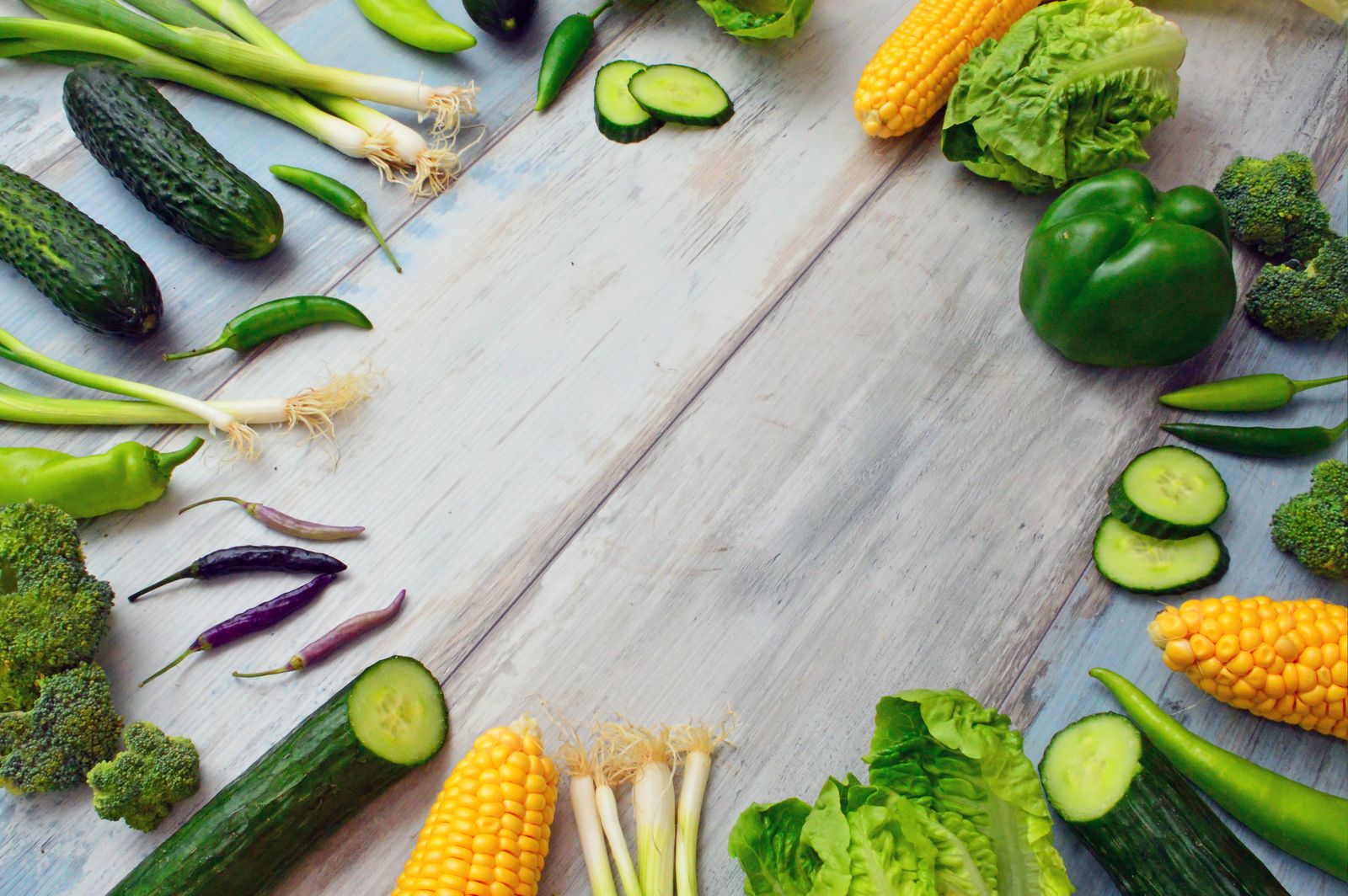 Fresh herbs and vegetables on a wooden surface
