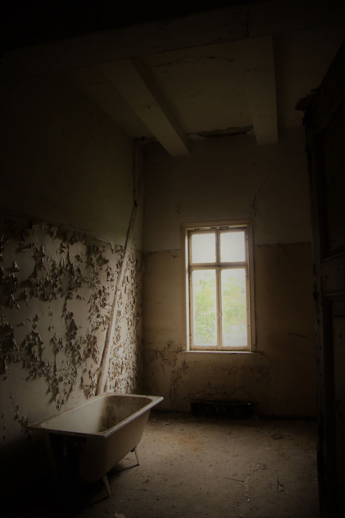 A fire- and smoke-damaged room before restoration, with peeling walls