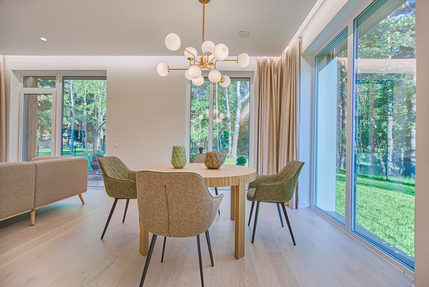 A bright, calm studio interior with warm wood, plants and large windows