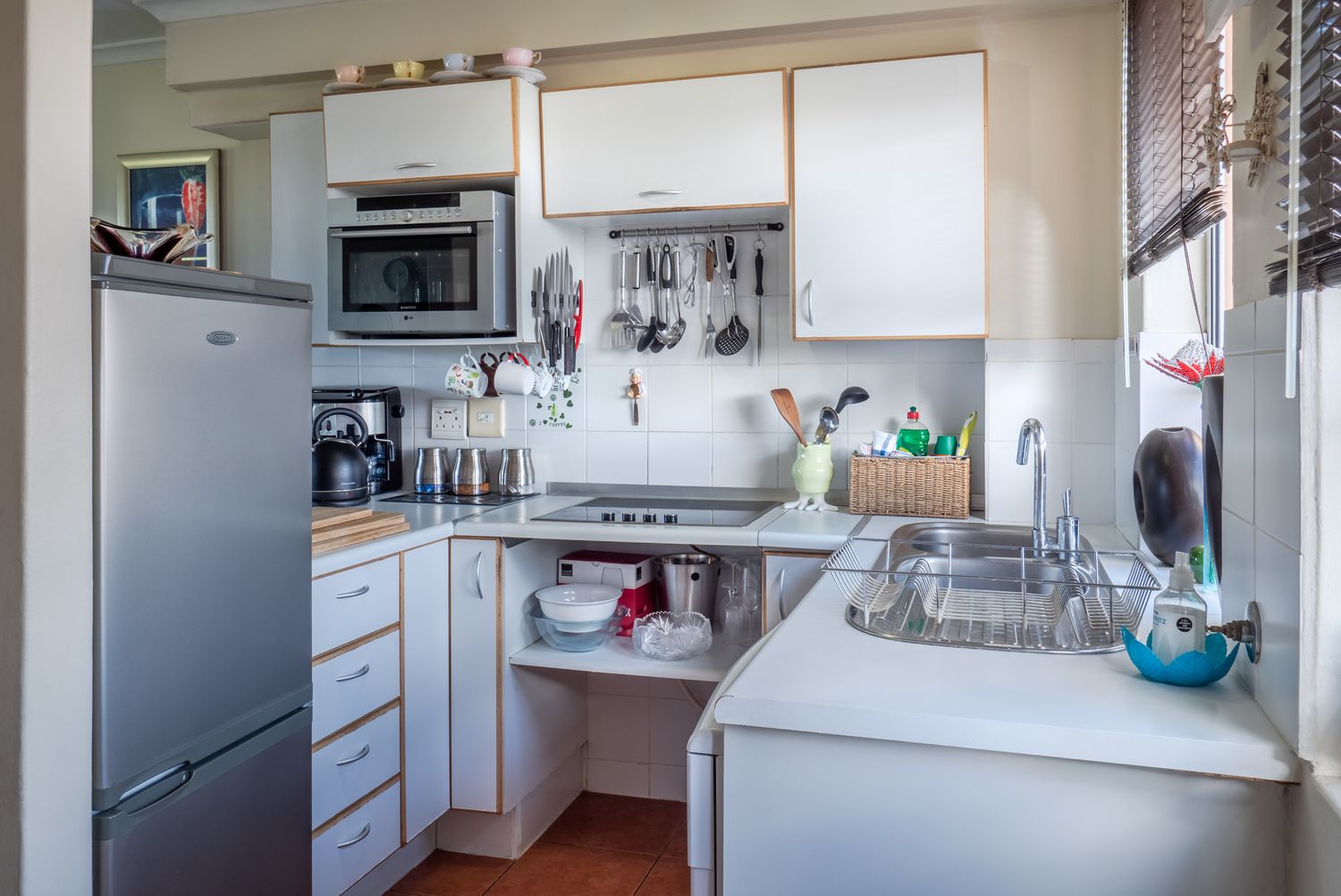 Renovated white kitchen with island and tiled backsplash