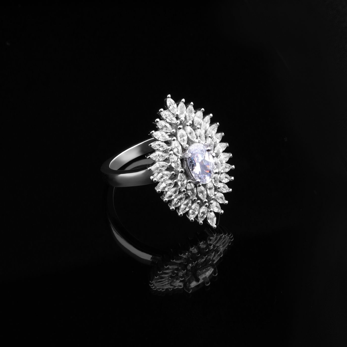 A marquise cluster ring on black
