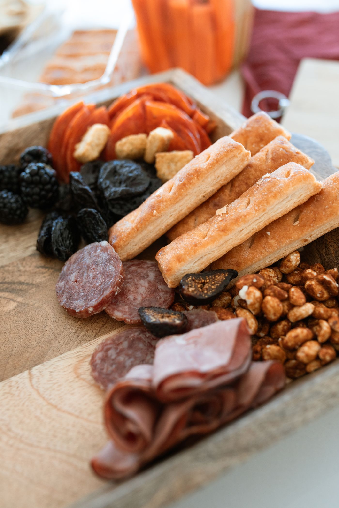 Charcuterie board with salami and breadsticks