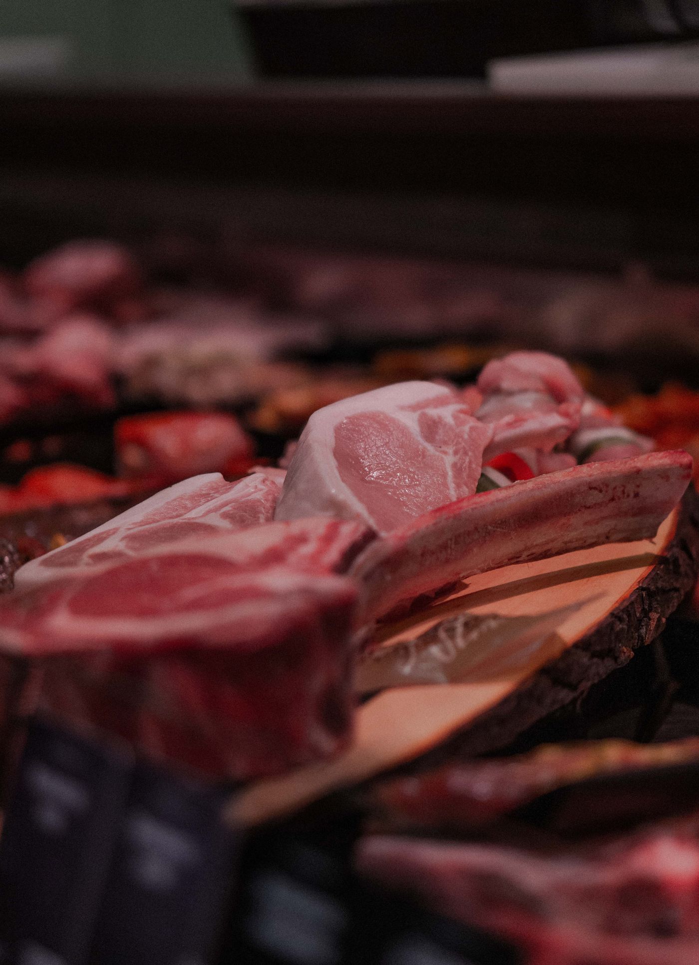 Fresh cuts of meat in a butcher's display case