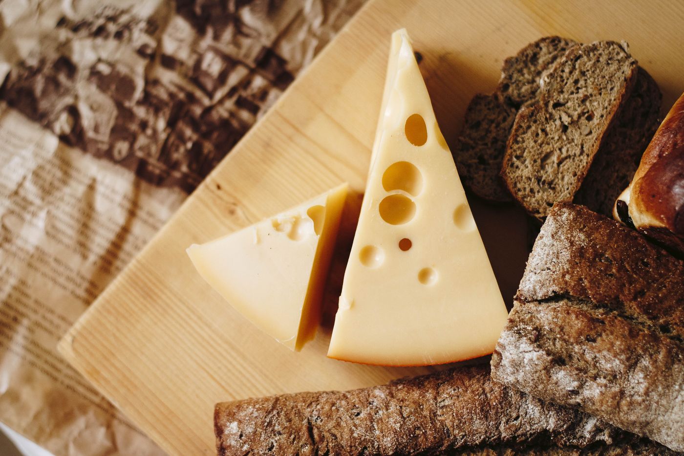 Wedge of cheese on a dark board