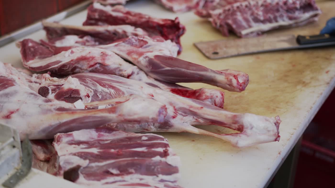 Raw cuts of meat arranged on a butcher's board