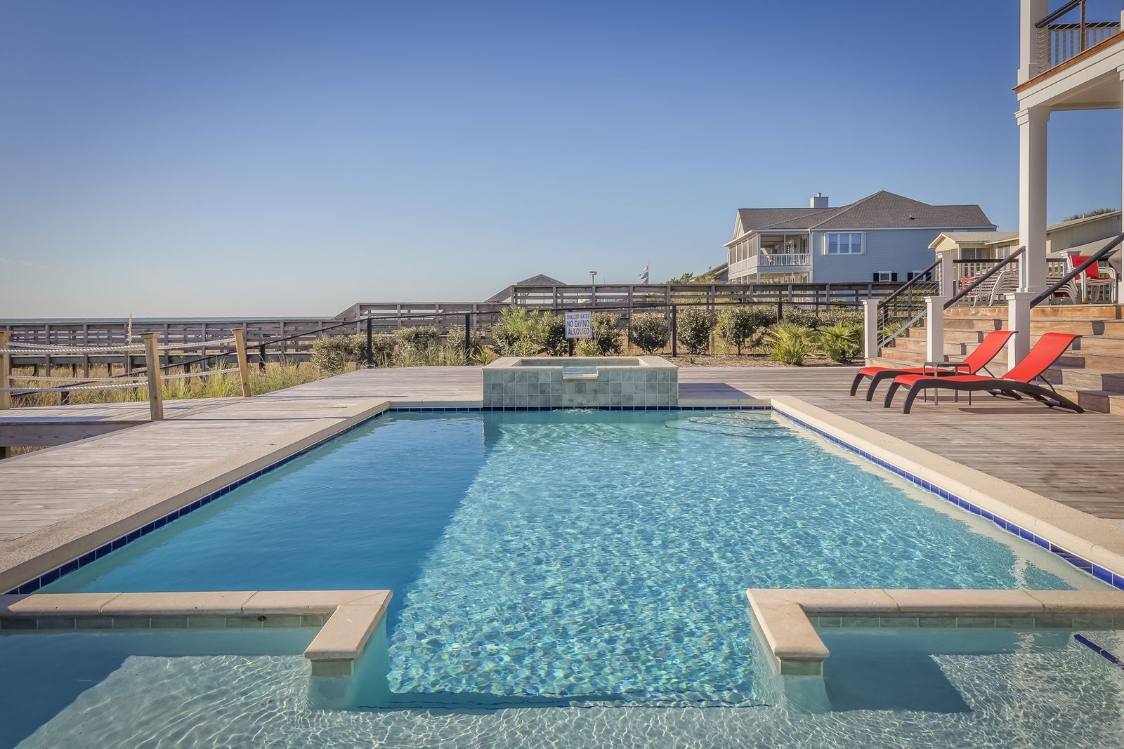Finished residential backyard pool and spa with paver deck