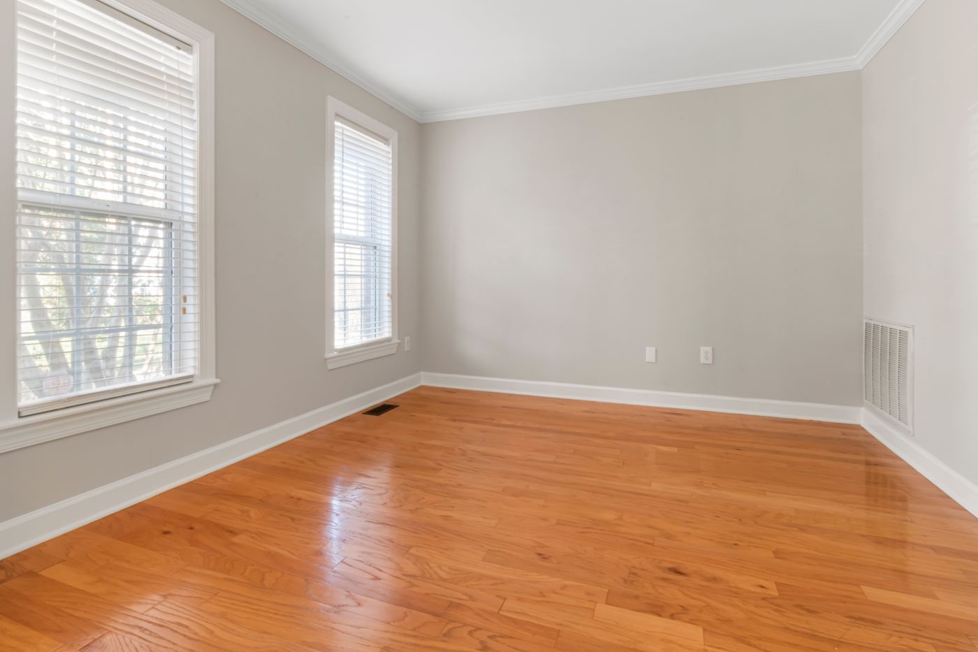 An empty room with natural light, swept after a move-out