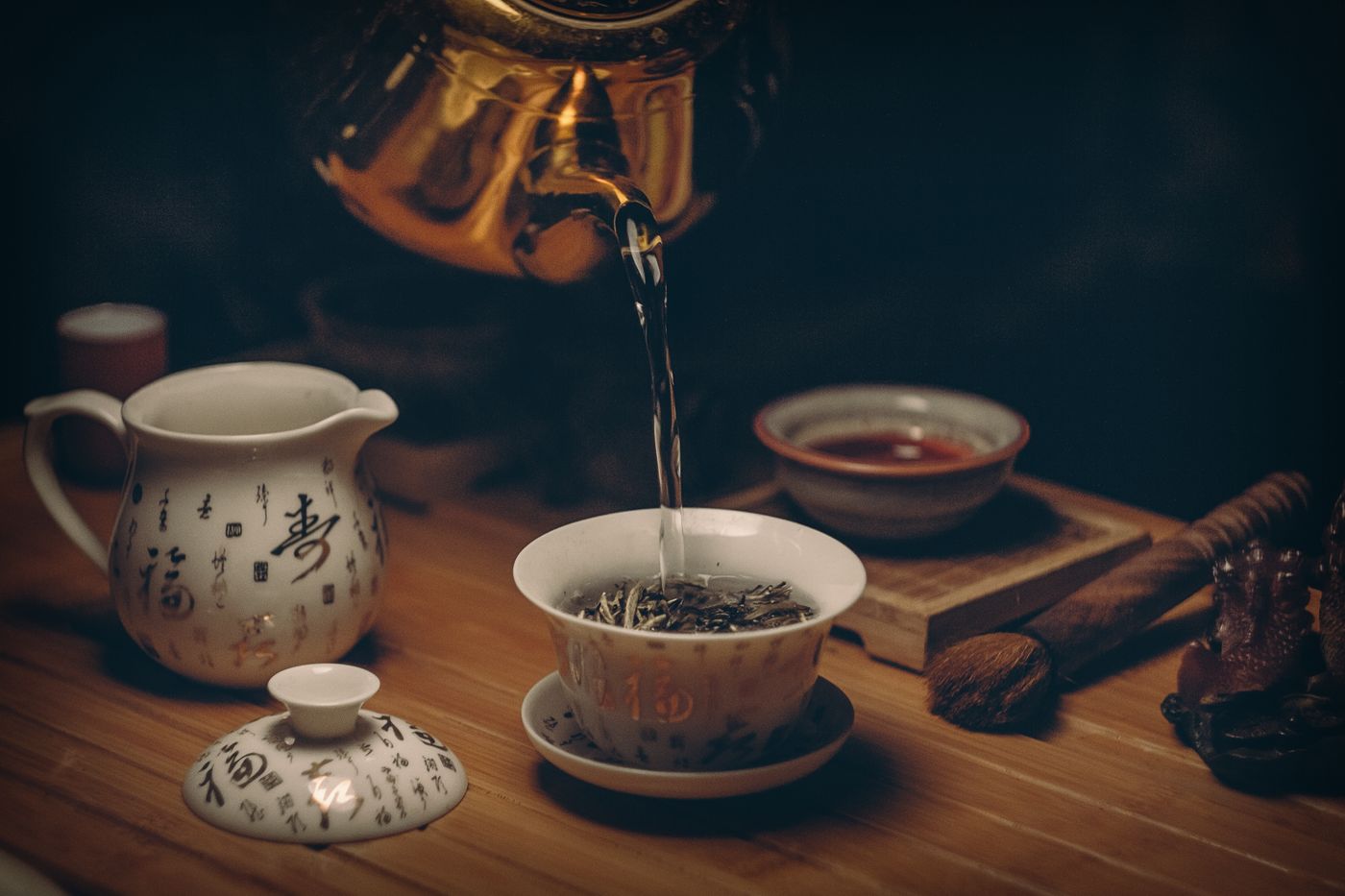 Tea poured from a Japanese teapot into a cup