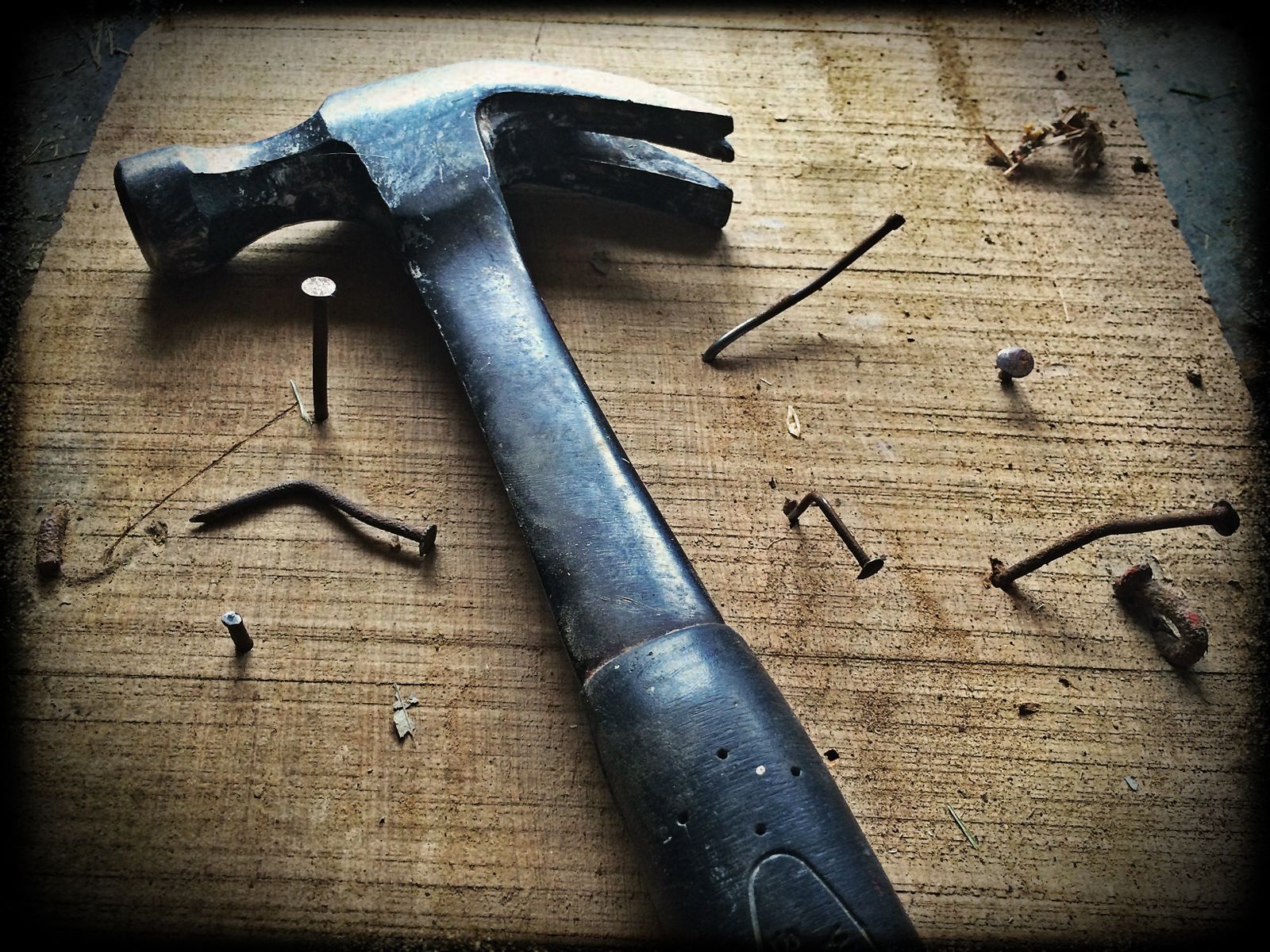 Hammer and nails on cedar boards