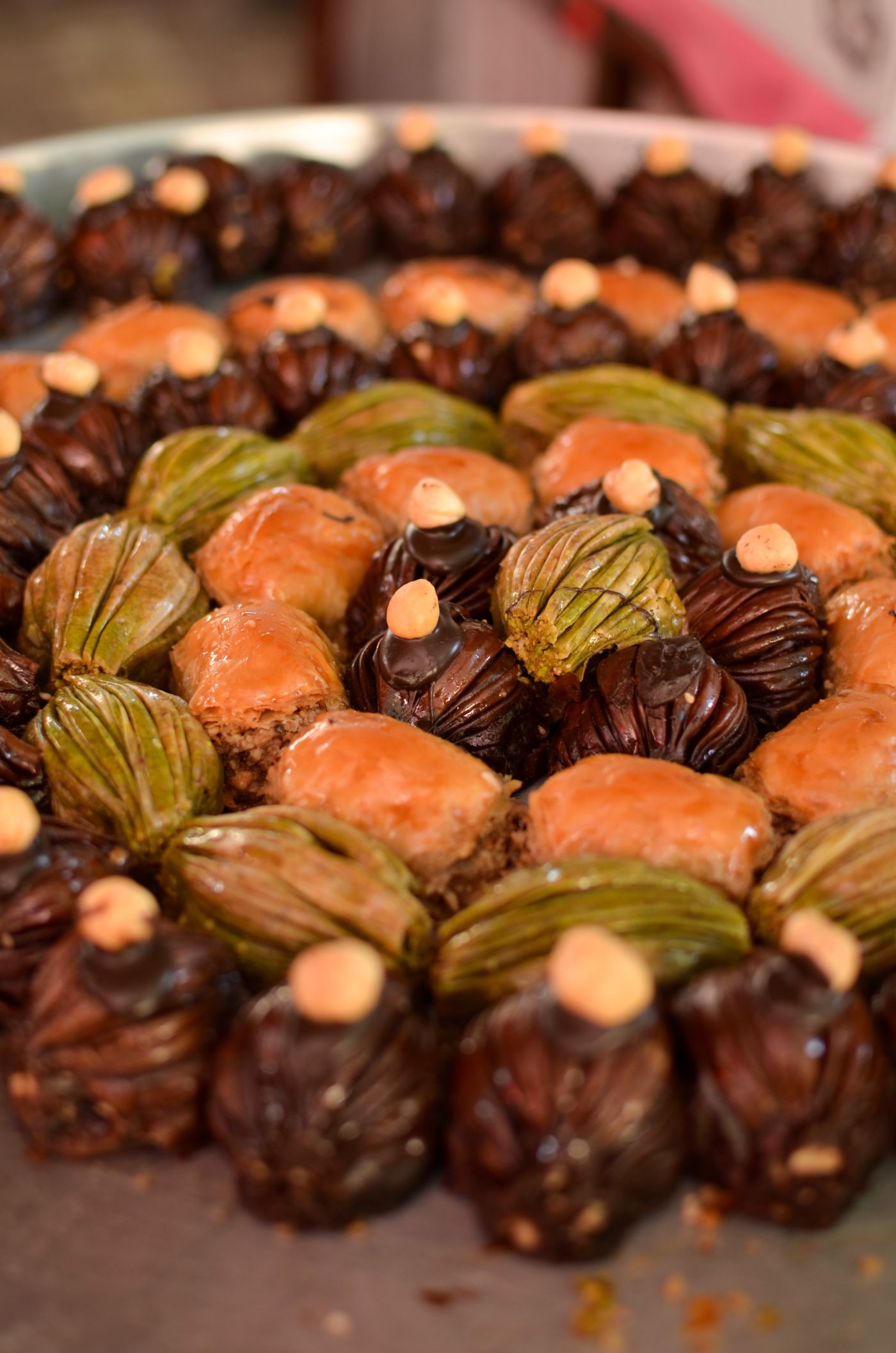 Assorted baklava arranged on a dark surface