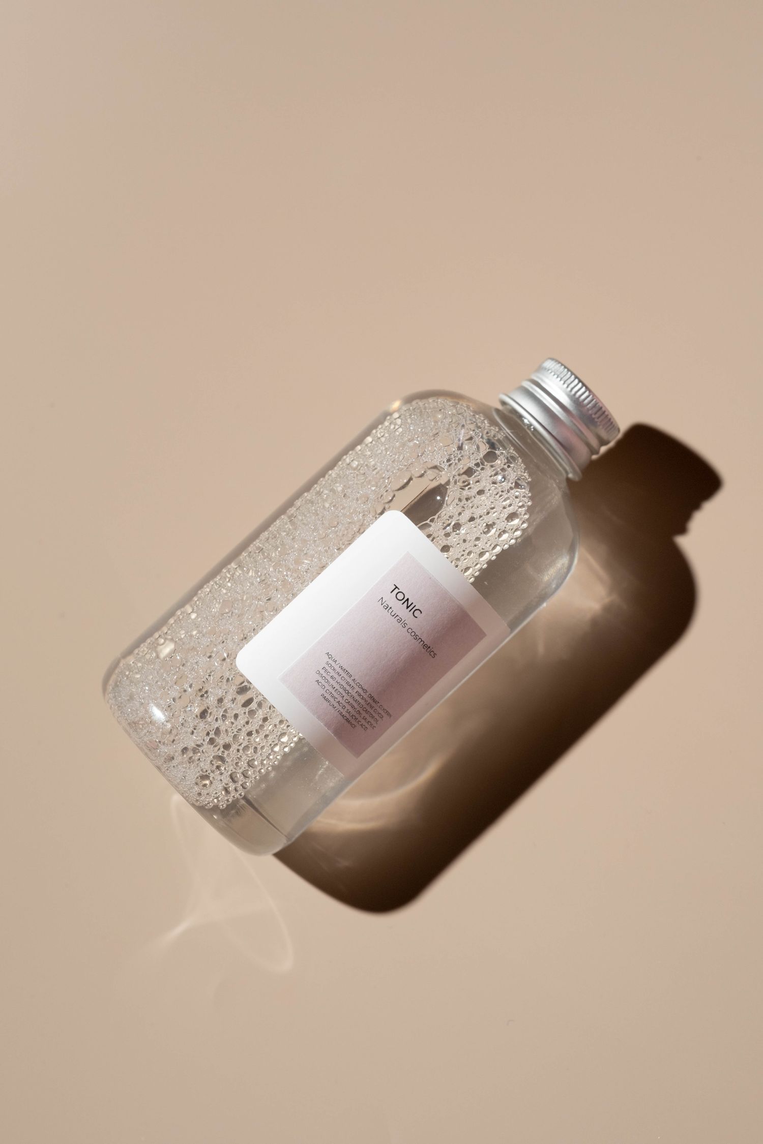 Clear toner bottle on warm background
