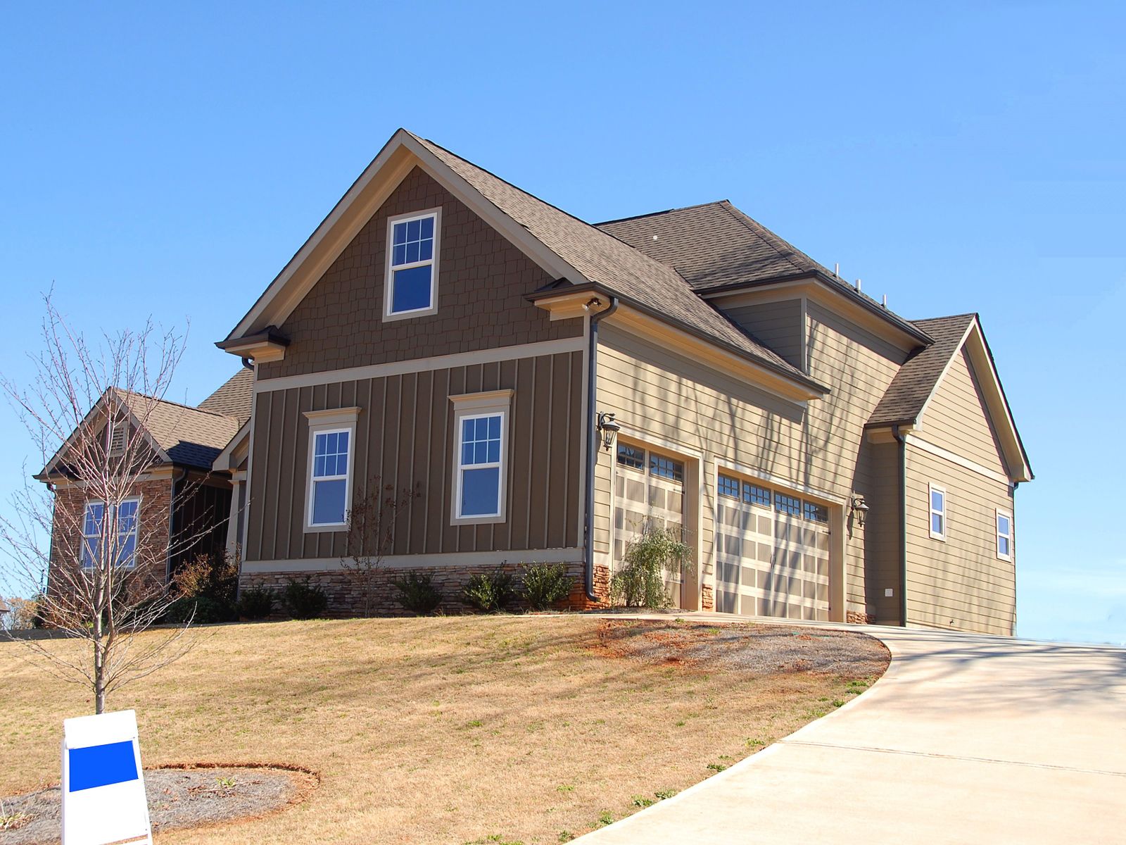 A two-storey home with a steep, sound shingle roof