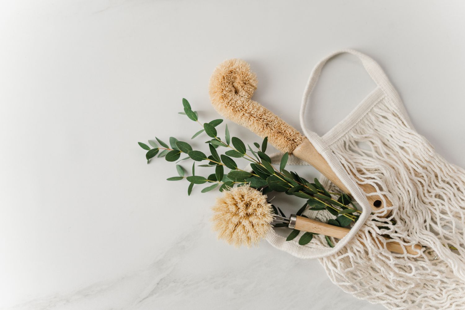 Dried botanicals with a mesh bag and wooden scoop