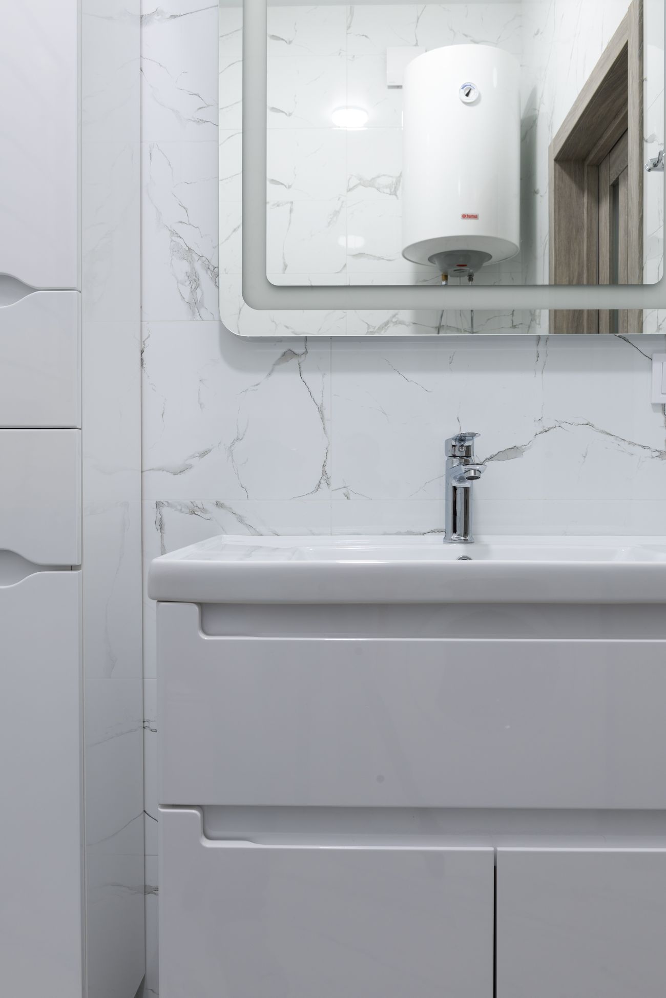 Wall-mounted water heater above a clean vanity